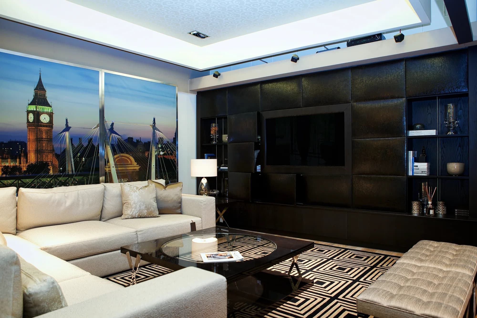 Dark fitted TV wall with textured panels, open side shelves and lower storage
