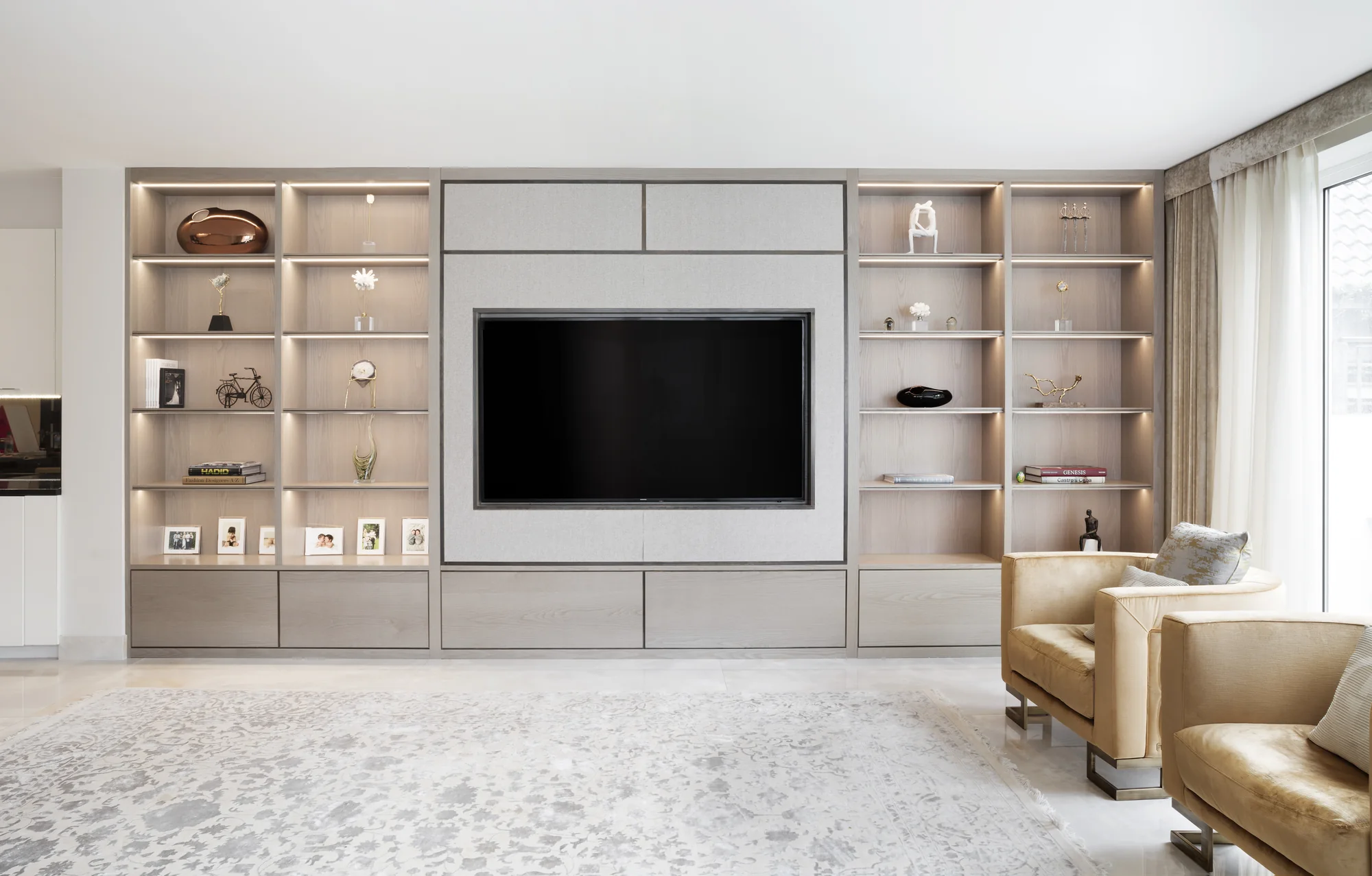Front view of bespoke media wall with display shelving