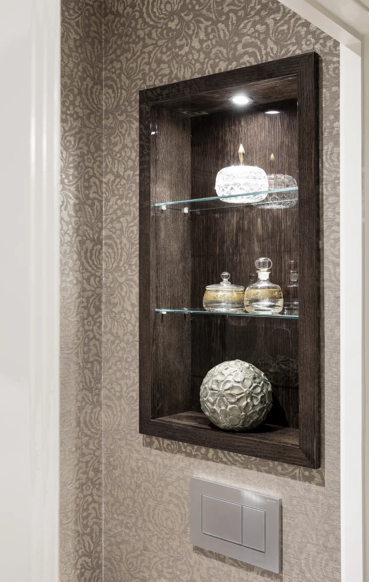 Recessed illuminated display niche with fitted shelving