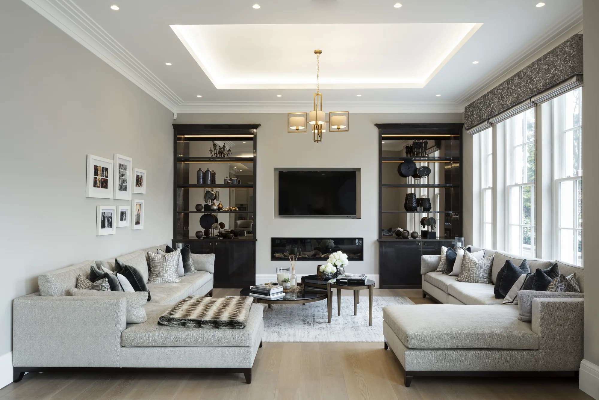 Full living-room view of modern alcove units around the television and fireplace