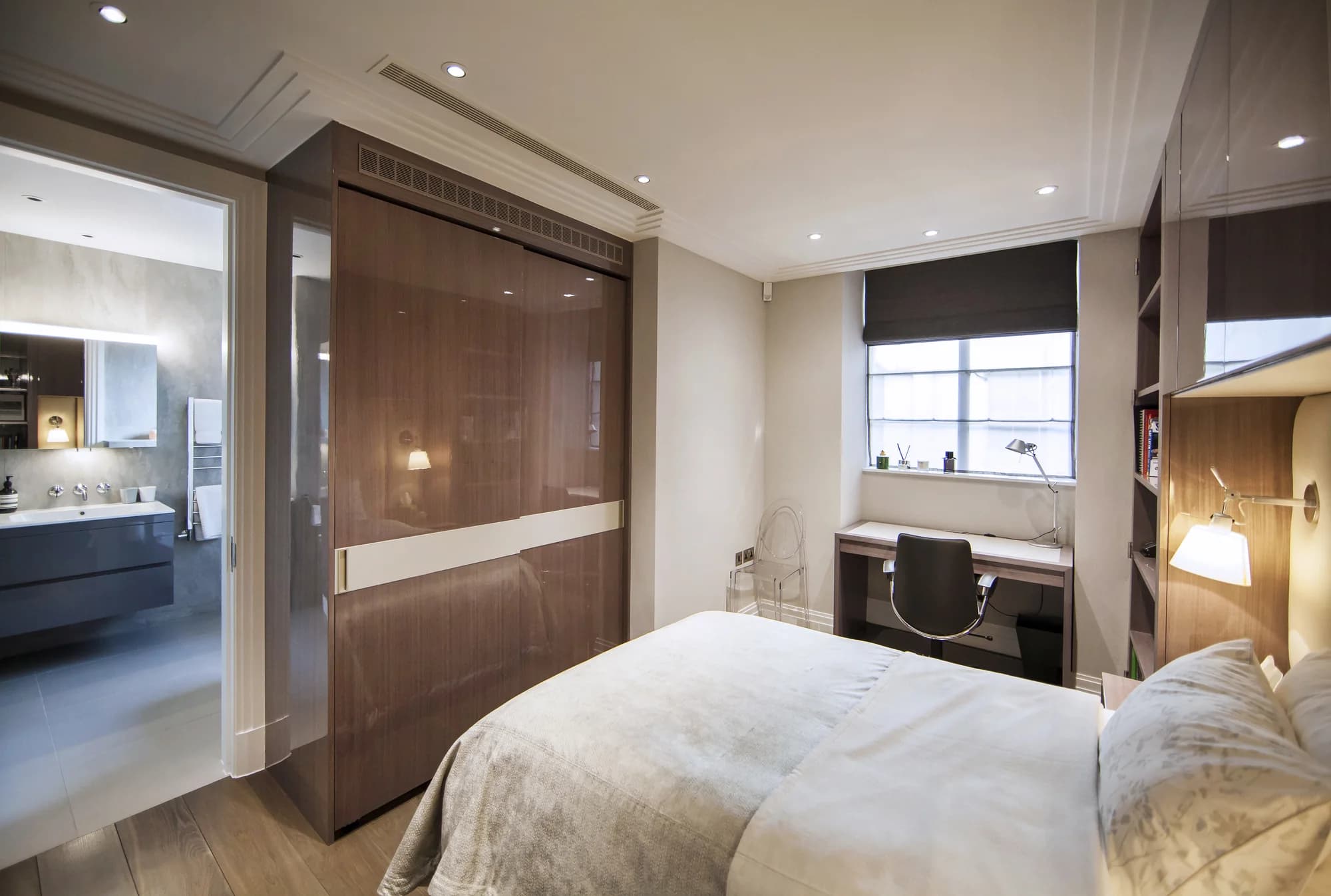 Closed glossy bedroom wardrobe doors with a contrasting pale horizontal band